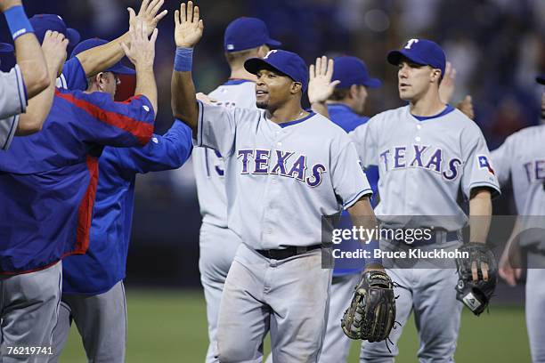 Marlon Byrd of the Texas Rangers celebrates the win over the Minnesota Twins after the game at the Humphrey Metrodome in Minneapolis, Minnesota on...