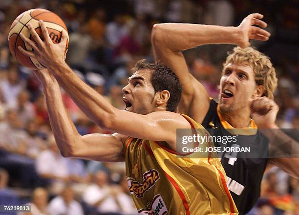 Spain's player Jose Manuel Calderon vies for the ball with German Dirk Nowitzki during their friendly match at the Fuente San Luis Sports Palace in...