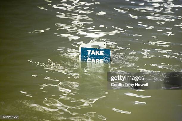 take care sign underwater, weston-super-mare, somerset, england - tony howell stock pictures, royalty-free photos & images