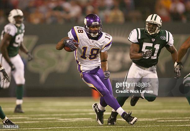 Sidney Rice of the Minnesota Vikings carries the ball against Jonathan Vilma of the New York Jets during their preseason game on August 17, 2007 at...