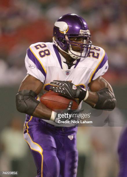 Adrian Peterson of the Minnesota Vikings carries the ball against the New York Jets during their preseason game on August 17, 2007 at Giants Stadium...