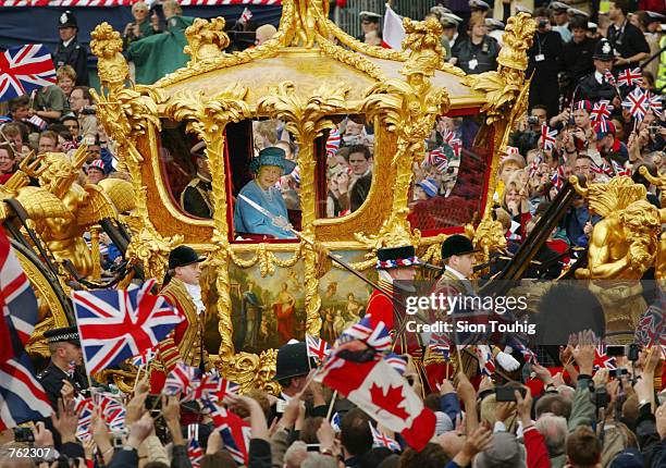 Britain's Queen Elizabeth and Prince Philip ride in the Golden State Carriage at the head of a parade from Buckingham Palace to St Paul's Cathedral...