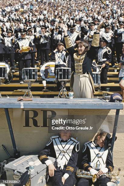 Two members of the University of California, Berkeley marching band sleep as the rest of the band and spectators cheer on the California Golden Bears...