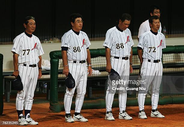 Japan baseball team manager Senichi Hoshino and coaches Koji Yamamoto , Koichi Tabuchi and Yutaka Ono listen to their national anthem during an award...