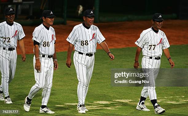 Japanese baseball team manager Senichi Hoshino , and coaches Koji Koichi Tabuchi , Yamamoto and Yutaka Ono walk walk out on the field after defeating...