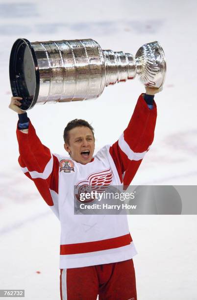 Igor Larionov of the Detroit Red Wings hoists the Stanley Cup after defeating the Carolina Hurricanes 3-1 in game five of the NHL Stanley Cup Finals...