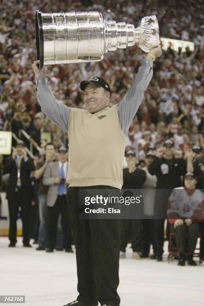 Head coach Scotty Bowman of the Detroit Red Wings celebrates with the Stanley Cup after defeating the Carolina Hurricanes in game 5 of the 2002...