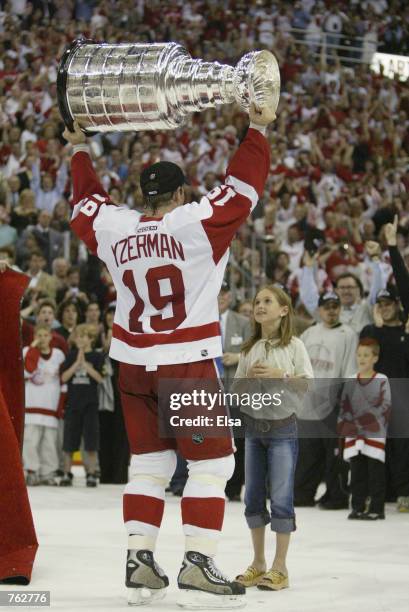 Steve Yzerman of the Detroit Red Wings celebrates with his daughter Isabella and the Stanley Cup after defeating the Carolina Hurricanes in game 5 of...