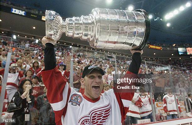 Brett Hull of the Detroit Red Wings celebrates with the Stanley Cup after defeating the Carolina Hurricanes in game 5 of the 2002 Stanley Cup Finals...