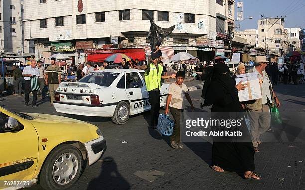 Volunteer member of Hamas directs traffic in a street in the southern Gaza Strip August 21, 2007 in Gaza City, Gaza Strip