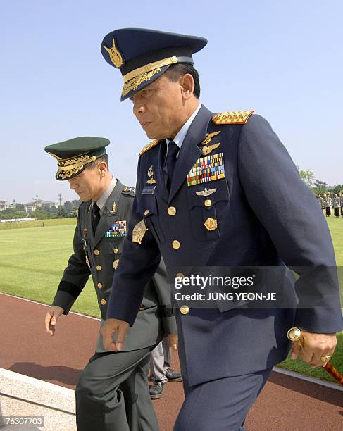 Indonesian Air Chief Marshal Djoko Suyanto , commander-in-chief of Indonesia's National Armed Forces, walks with Kim Kwan-Jin , chairman of the South...