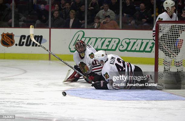 Out of position goaltender Jocelyn Thibault and defenseman Jon Klemm of the Chicago Blackhawks watch a loose puck wander outside an open net during...