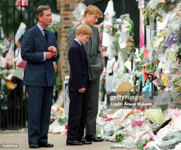 The Prince of Wales, Prince William and Prince Harry look at floral tributes to Diana, Princess of Wales outside Kensington Palace on September 5,...