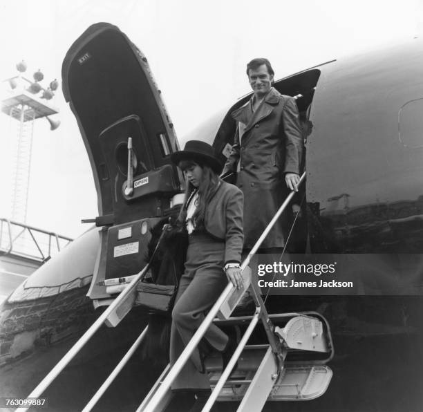 Playboy impresario Hugh Hefner and his girlfriend, Barbi Benton, arriving at Gatwick Airport, 20th February 1971.
