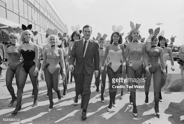 Playboy impresario Hugh Hefner with a group of bunny girls at London Airport , 25th June 1966. Hefner has flown in for the opening of the London...