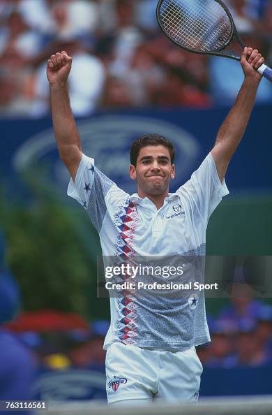 American tennis player Pete Sampras raises his arms in the air in