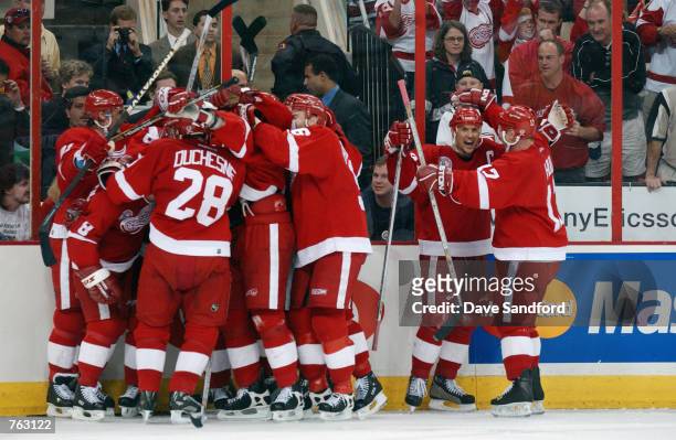 Steve Yzerman of the Detroit Red Wings celebrates the win in triple overtime with his teammates against the Carolina Hurricanes in game three of the...