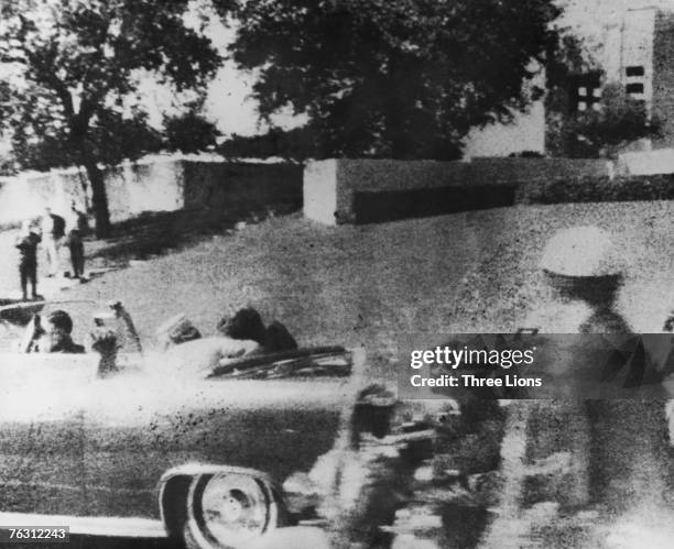 American president John F. Kennedy is struck by an assassin's bullet as he travels through Dallas in a motorcade, 22nd November 1963. In the car next...