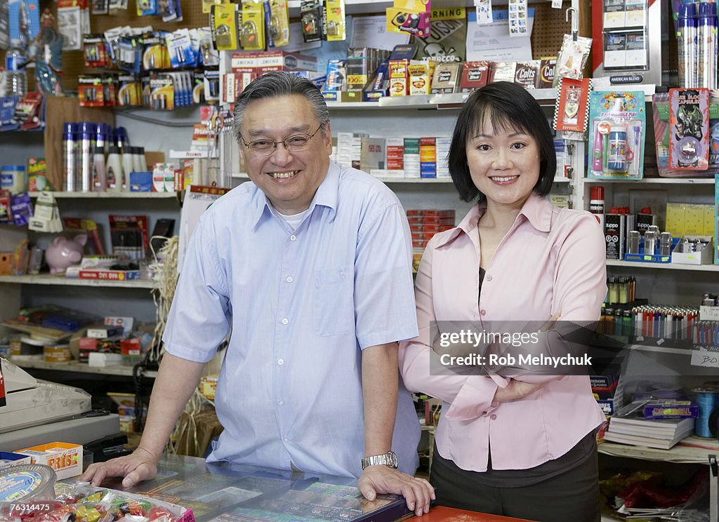 Shop owner and wife, behind shop counter, portrait