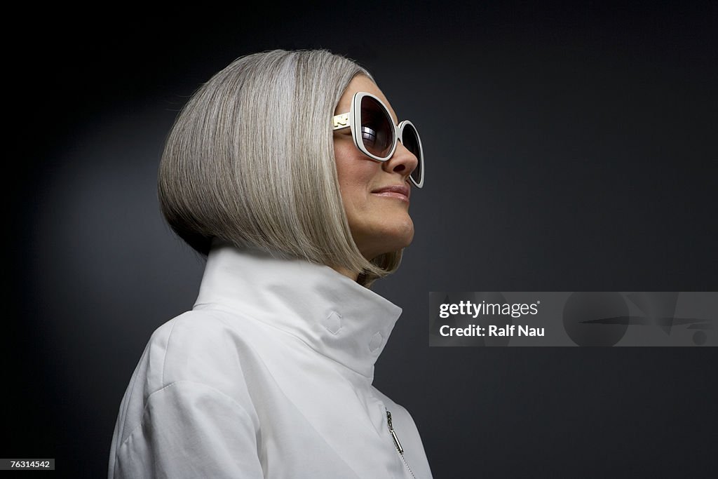 Mature woman wearing sunglasses, side view, close-up