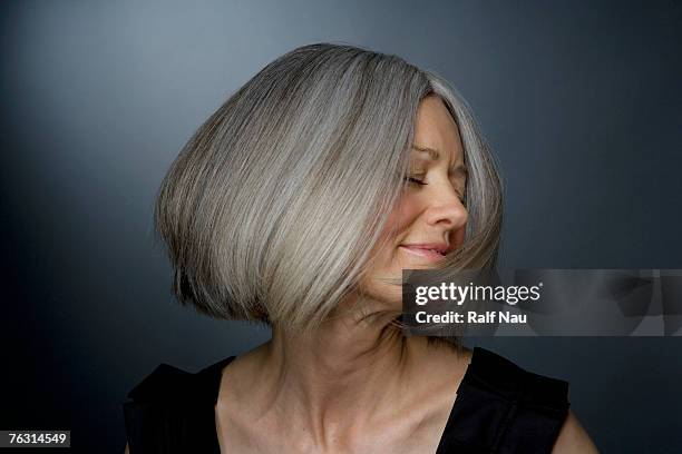 mature woman turning head, eyes closed, close-up - hair woman mature grey hair beauty stock pictures, royalty-free photos & images