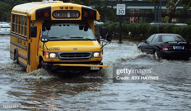 School bus in Geneva, Illinois tries to drive through a flooded street 24 August, 2007 along the Fox River in Illinois. Flooding along rivers in the...