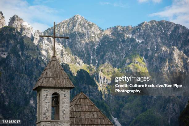 village church bell tower and accursed mountains, theth, tirana, albania - tirana stockfoto's en -beelden