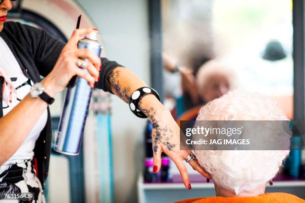 woman working in quirky hair salon - best beauty salon stock pictures, royalty-free photos & images