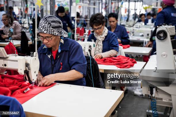 seamstresses working in factory, cape town, south africa - garment factory stock pictures, royalty-free photos & images