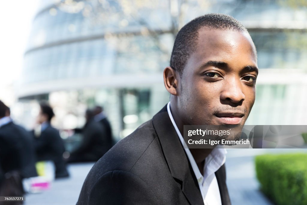 Portrait of man, City Hall in background, London, UK