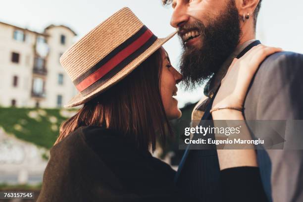 young woman in straw boater laughing with boyfriend - straw boater hat photos et images de collection