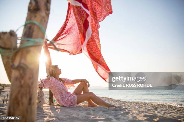 woman sitting on beach relaxing, palma de mallorca, islas baleares, spain, europe - palma majorca stock pictures, royalty-free photos & images