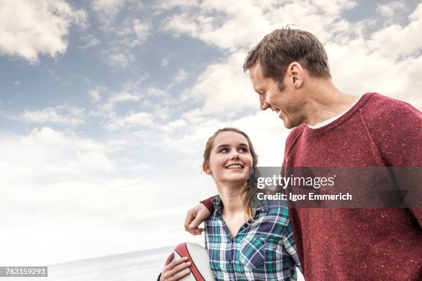 father and daughter walking along beach together - 16 17 years stock pictures, royalty-free photos & images