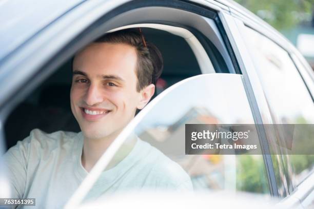 new york, brooklyn, man in drivers seat, portrait - car ownership stock-fotos und bilder