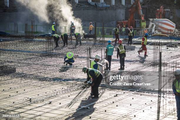construction workers laying foundation of building - building foundations stock pictures, royalty-free photos & images