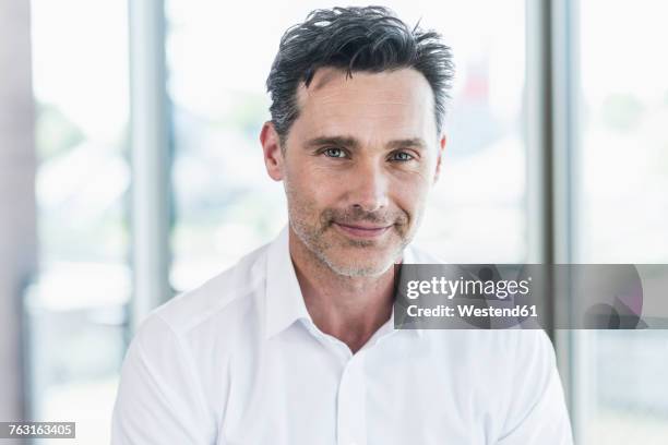 portrait of smiling businessman - hair stubble stock-fotos und bilder