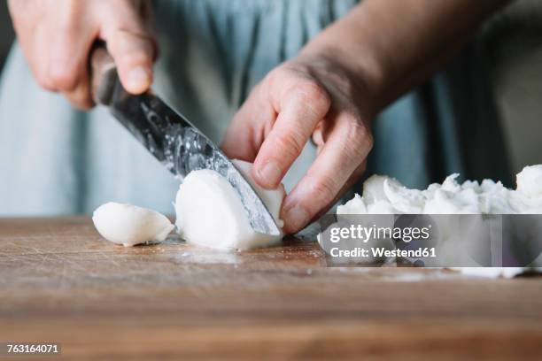 close-up of woman cutting mozzarella - mozzarella stock-fotos und bilder
