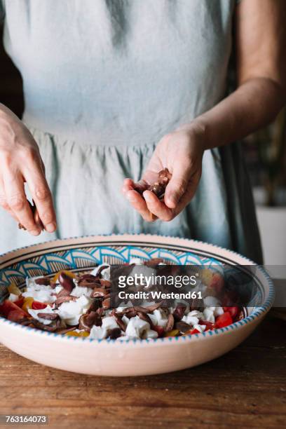 close-up of woman preparing fresh food with olives - salad tossing stock pictures, royalty-free photos & images