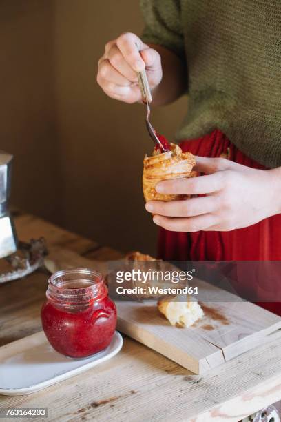 close-up of woman tasting homemade croissants with jam - verteilung stock-fotos und bilder
