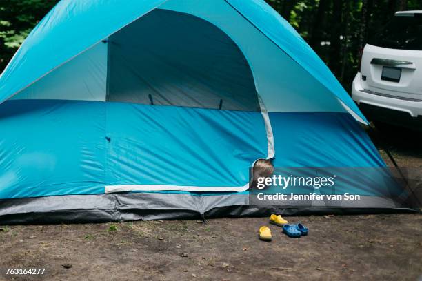 head shot portrait of cute male toddler peeking from blue tent, huntsville, canada - the comedy tent stock pictures, royalty-free photos & images