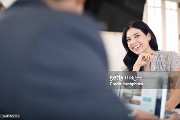 happy young businesswoman working at desk - heshphoto stock pictures, royalty-free photos & images