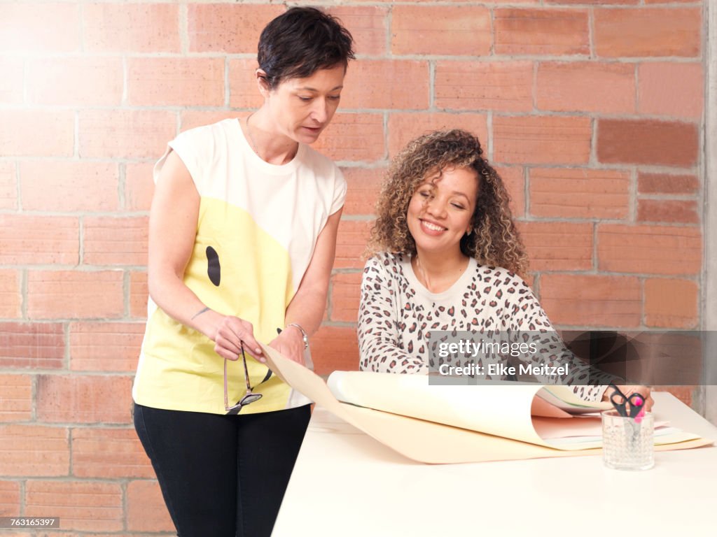 Colleagues looking at blueprint