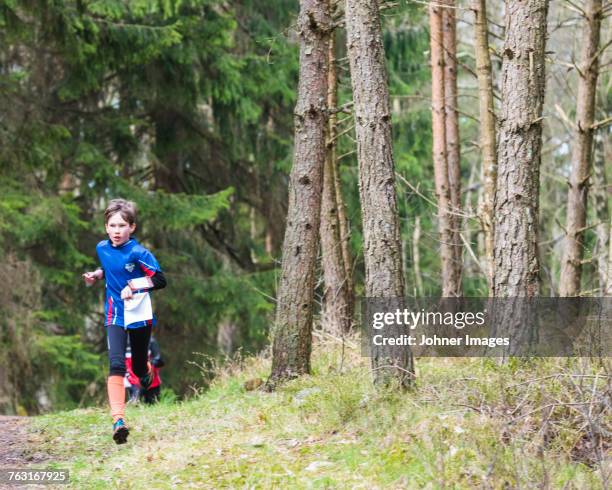 boy running in forest - orienteering run stock pictures, royalty-free photos & images