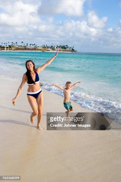 mother with son on beach - aruba bildbanksfoton och bilder