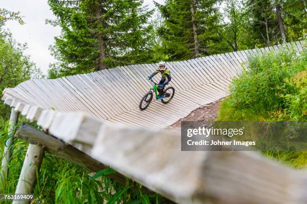 cycling on wooden cycling track - dalarna stock pictures, royalty-free photos & images