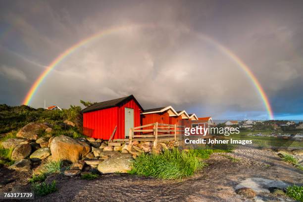 rainbow above wooden buildings - halland stock pictures, royalty-free photos & images