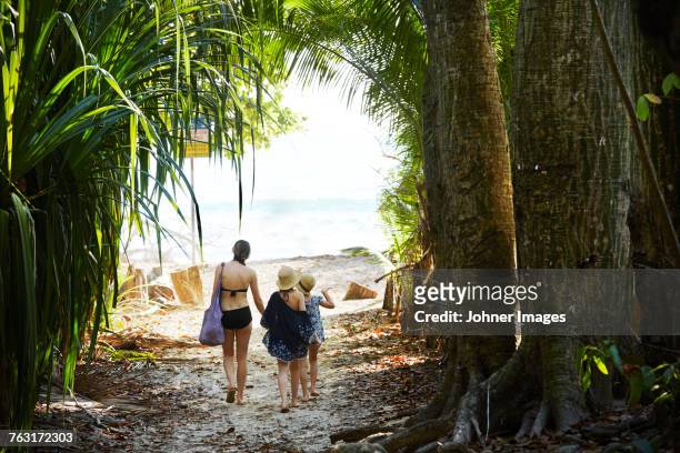 mother with daughters walking at beach - costa rica beach stock pictures, royalty-free photos & images