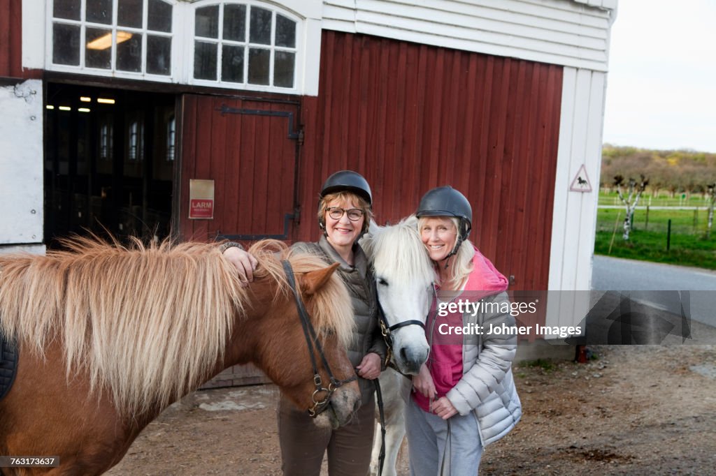 Mother and daughter with ponies