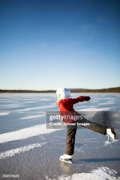 girl on frozen lake - winter sport gear stock pictures, royalty-free photos & images