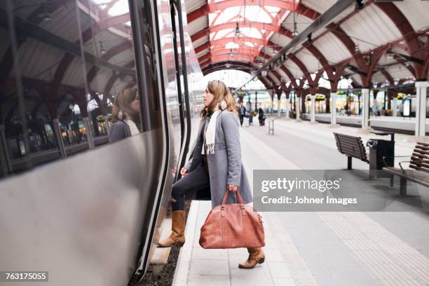 woman entering train - malmo stock pictures, royalty-free photos & images